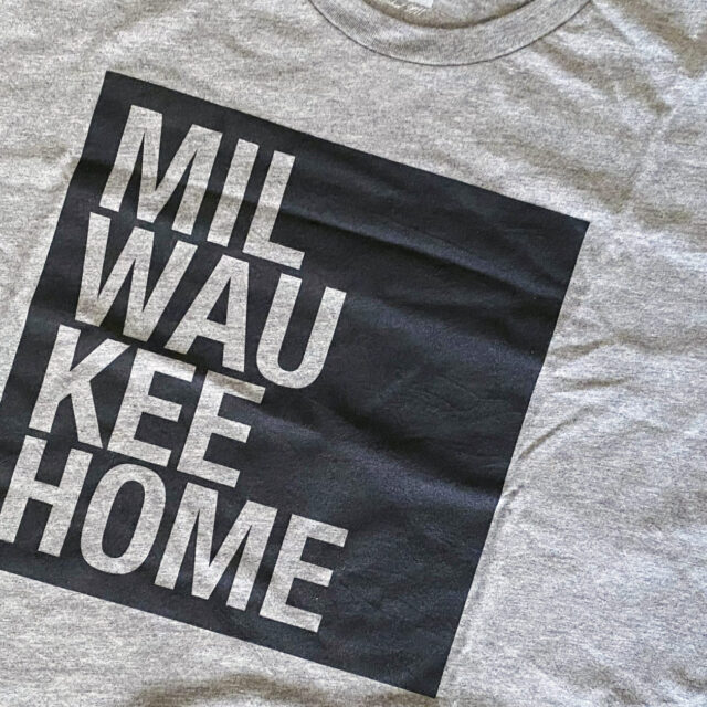 Milwaukee apparel from MKEhome (a t-shirt and mask laying on the floor)
