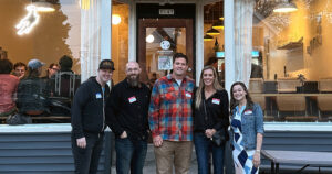 From left to right: JMatt, Nick of @Milweb1, Adam and Hannah of @GettingStamped, and Meg of @MilwaukeePhoto. Group of 5 people stand shoulder to shoulder outside of the main entrance to Supermoon Beer Company in Bay View.